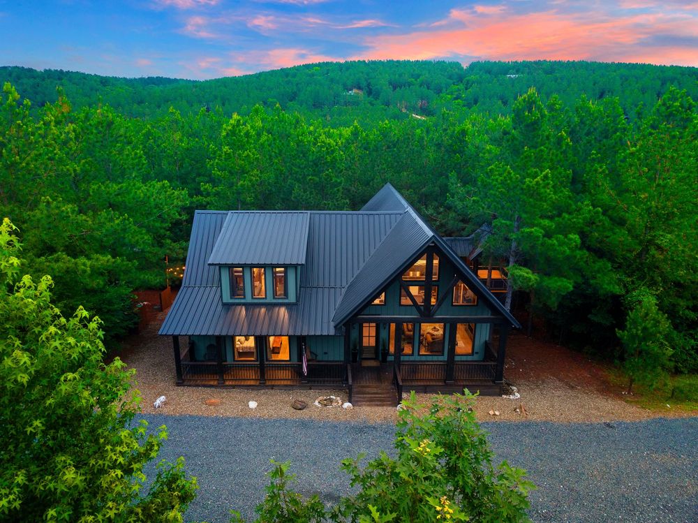 Emerald Vista Cabin at dusk, seen from above the pines